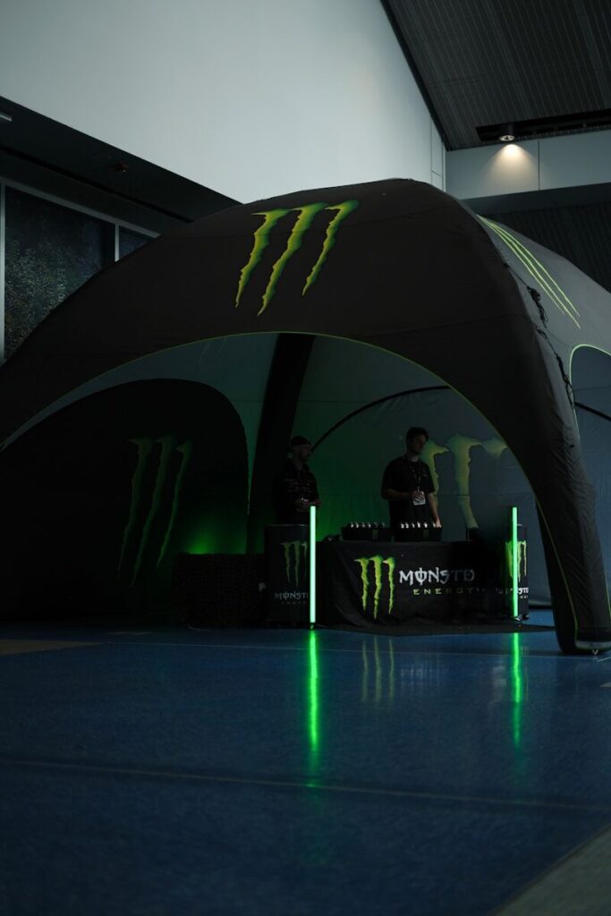 Monster energy branded tent with two people inside